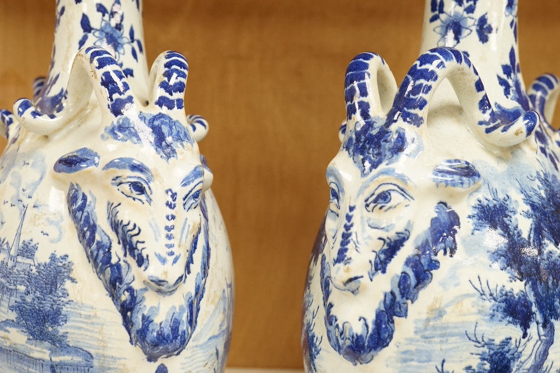 A pair of late 19th century Delft blue and white flagons, 31cm. Condition - fair